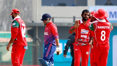 Oman's Mohammad Nadeem celebrates a wicket against Nepal at the Tribhuvan University. Subas Humagain for The National