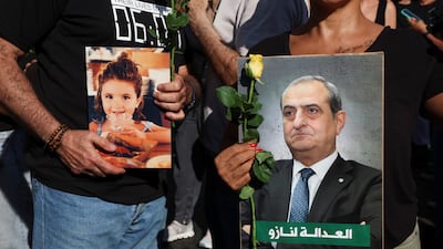 Relatives of some of the victims of the Beirut port blast carry pictures during the march. Reuters