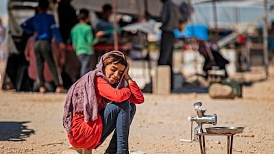 A displaced Syrian girl sits next to a grinder, to grind meats or vegetables, at the Washukanni camp for the internally displaced in Syria's northeastern Hasakeh province on May 10, during the month of Ramadan. In Syria, UNICEF is transporting clean water into some of the most devastated cities and camps. Delil Souleiman / AFP