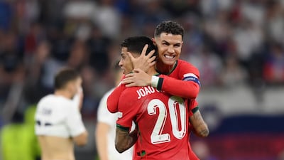 Cristiano Ronaldo and Joao Cancelo of Portugal celebrate after their team's penalty shoot-out victory against Slovenia in the last 16 of Euro 2024 at Frankfurt Arena on July 1, 2024. The game ended 0-0 after extra time but Portugal won 3-0 on penalites. Getty Images