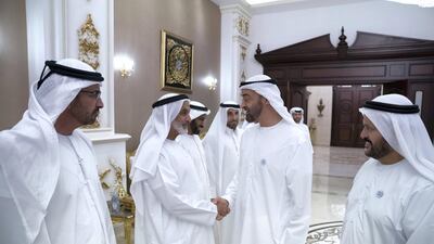 Sheikh Mohamed bin Zayed greets Mohammed Al Remeithi (2nd L), during a visit to the house of Maj Gen (Ret) Al Mazrouei (R), in Khalifa City. Hamad Al Kaabi / Ministry of Presidential Affairs
