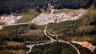 Vehicles are seen near Colonial Pipeline in Helena, Alabama. Colonial Pipeline said in a statement late Friday that it “took certain systems offline to contain the threat, which has temporarily halted all pipeline operations, and affected some of our IT systems.” AP Photo