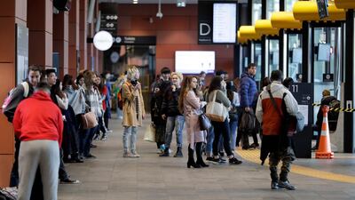 Commuters wait for transport at a bus interchange in Christchurch, New Zealand. AP Photo