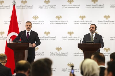 Syrian Foreign Minister Asaad Al Shibani, right, and his Turkish counterpart Hakan Fidan at a joint press conference in Damascus on Monday. AP