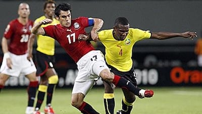Egypt's captain Ahmed Hassan, left, is tackled by Mozambique's Junior Simao during the Group C match.