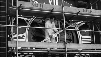 A worker positioning the single hand of the Ting-Tang Quarter Turret clock after it was removed for cleaning in 1960
