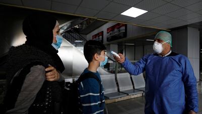 A health official tests passengers as part of security measures to avoid coronavirus in the country, at Damascus international airport, Damascus, Syria March 9, 2020. Reuters