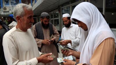 Afghan money changers gather to deal with foreign currency at a money change market in Herat province, Afghanistan June 3, 2018. Picture taken June 3, 2018. Jalil Ahmad / Reuters