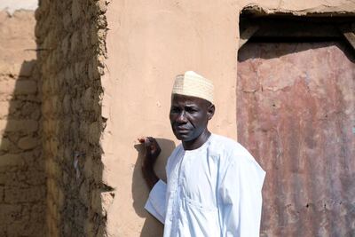 A man looks on, as his son, who attended a madrassa, gives an interview. REUTERS