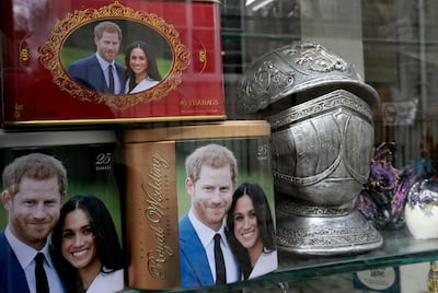 Memorabilia with a photograph the image of Britain's Prince Harry and Meghan Markle are displayed for sale in a shop window in Windsor. AP