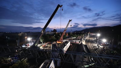 Rescuers uses crane to remove the derailed train on the site of accident in Yilan, Taiwan. EPA