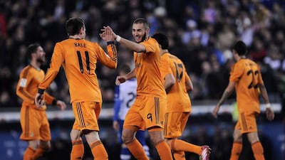 Karim Benzema, right, celebrates after scoring for Real Madrid on Tuesday. Josep Lago / AFP