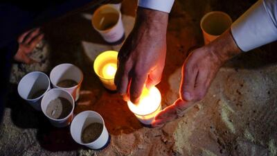 Mourners light candles during a vigil held on Kite Beach, Jumeirah, for murdered American Ibolya Ryan. The ideology that inspired her killer must be tackled head-on, writes Faisal Al Yafai (Photo: Antonie Robertson/The National)