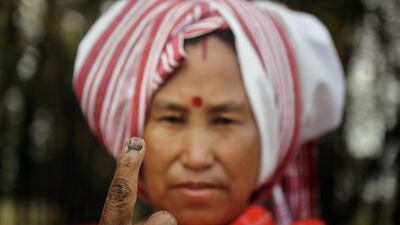 A Mishing tribal woman displays her indelible ink mark on her finger after casting her vote outside a polling station during the first phase of elections at Misamora Sapori, an island in the River Brahmaputra in Assam state. AP / Anupam Nath