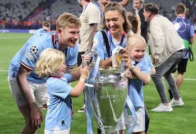 Manchester City player Kevin De Bruyne, his wife Michele and two of their children with the trophy. EPA