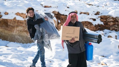Refugees are given a stove in Arsal last month, as part of the UNHCR efforts to help them battle the bitter winter conditions. Courtesy UNHCR