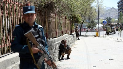 Afghan security personnel stand guard on the perimeter of the communication ministry during an attack claimed by ISIS on April 20, 2019. AP