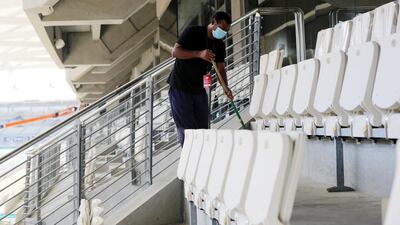 A cleaner sweeps the stands where tens of thousands of viewers are expected this week. Chris Whiteoak / The National
