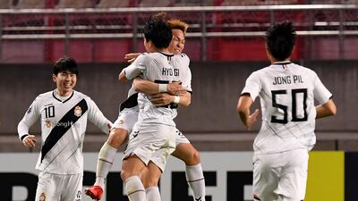 Takahiro Kunimoto, centre, celebrates with teammates after scoring the only goal of the game against Kahima Antlers. AFP