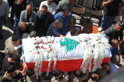 Mourners carry the coffin of Lebanese journalist Amal Khalil during her funeral procession in Bissariye town, south of Sidon on April 23. AFP