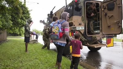 Army personnel assist a family being evacuated from rising flood waters in Rosslea. EPA
