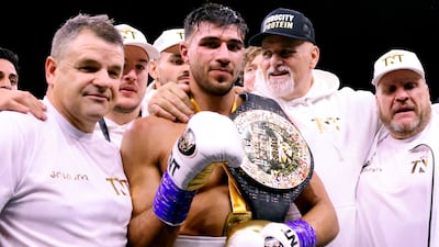 Tommy Fury poses for photographs with his coaching team. PA