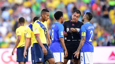 Brazil captain Dani Alves speaks with Chilean referee Julio Bascunan. Frederic J. Brown / AFP