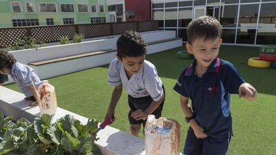 Pupils tend to the garden at Dubai British School Jumeirah Park. The project is part of a campaign to encourage healthy eating. Antonie Robertson / The National