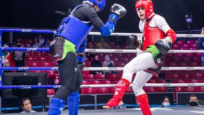 Zineb Bouhmada of UAE, blue, battles Fatemeh Hoseinikahaki of Iran.