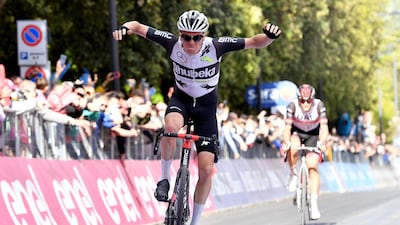 Qhubeka Assos rider Mauro Schmid of Switzerland celebrates winning Stage 11, from Perugia to Montalcino, with UAE Team Emirates' Alessandro Covi finishing second in the background. Reuters