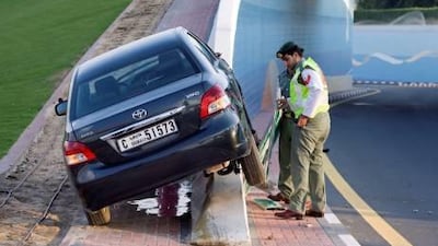 Police set an exit sign upright after a driver missed a turn on Airport Road and drove up a flyover embankment.