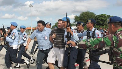 Australian Matt Christopher is escorted away by Indonesian military officers at Ngurah Rai International Airport in Bali, Indonesia, on April 25, 2014, after causing a hijack scare on a flight from Brisbane. EPA