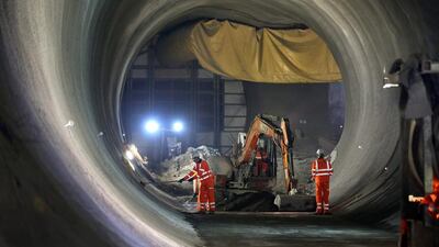Workers prepare the walls in the partially completed Crossrail rail tunnel that will become Bond Stret station. Peter Macdiarmid / Getty Images