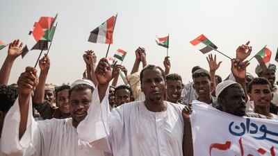 Supporters wave miniature Sudanese national flags as they wait for the deputy head of Sudan's ruling Transitional Military Council (TMC) and commander of the Rapid Support Forces (RSF) paramilitaries to arrive for a rally in the village of Abraq, about 60 kilometres northwest of Khartoum. AFP