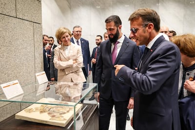 Ahmad Al Shara and Emmanuel Macron inspect repatriated Syrian artefacts. Sana / AFP