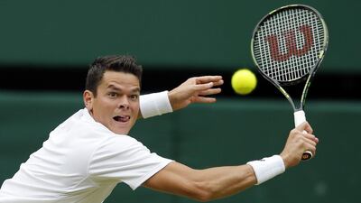Milos Raonic of Canada returns to Roger Federer of Switzerland during their men's semi-final singles match on Day 12 of the Wimbledon Tennis Championships in London, Friday, July 8, 2016. (AP Photo/Alastair Grant)
