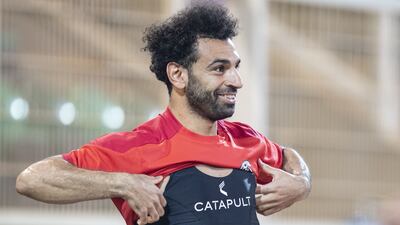 Egypt's Mohamed Salah puts his jersey on during a training session at the Olembe Stadium in Yaounde on February 5, 2022 on the eve of the 2021 Africa Cup of Nations final against Senegal. AFP