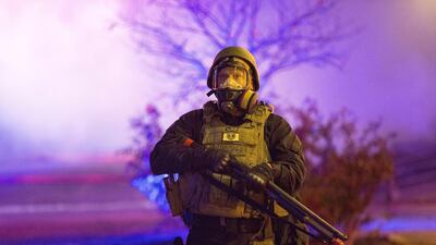 Police stand guard during rioting on Monday in Ferguson, Missouri. Aaron P. Bernstein / Getty Images / AFP