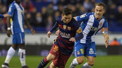 Barcelona's Lionel Messi, left, vies with Espanyol's Abraham Gonzalez during the Spanish Copa del Rey (King's Cup) round of 16 second leg football match at Cornella-El Prat stadium in Cornella near Barcelona, on January 13, 2016. AFP PHOTO/ LLUIS GENE