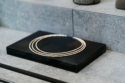 Beaded chalk necklaces are among the locally discovered items displayed at Louvre Abu Dhabi. Khushnum Bhandari / The National