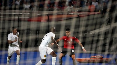 Egypt's Zizo, right, and Guinea's Conte are seen through the goal net during their soccer match in Group D 2023 Cup of Nations (AFCON) qualifiers at Cairo International stadium in Cairo, Egypt. Egypt won 1-0. AP Photo