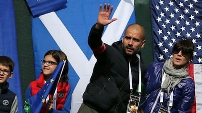 Former Barcelona football team manager Pep Guardiola and wife Cristina Serra and family stand behind the first tee box before the Singles Matches for The 39th Ryder Cup at Medinah Country Club on September 30. Ross Kinnaird / Getty Images /AFP