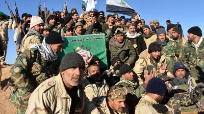 Members of the Imam Ali Division, one of the groups fighting with the Hashed Al Shaabi (Popular Mobilisation) paramilitary umbrella group, celebrate after the Iraqi prime Minister declared victory in the war against ISIL, about 80 kilometres west along the Syrian border from the town of Al Qaim, on December 9, 2017. AFP