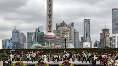 Pedestrians along the Bund in Shanghai. China's economic growth has slowed significantly after sharp expansion earlier this year. Bloomberg