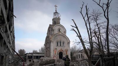 A Ukrainian serviceman near a damaged church after shelling in a residential district of Mariupol. AP