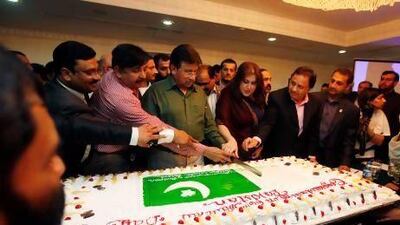 Former Pakistan president Pervez Musharraf celebrates Pakistan's national day by a cutting a cake with party supporters in Dubai, where he repeated his call for security when he returns to Pakistan. Satish Kumar / The National
