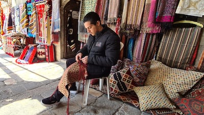 Maher Derki, 17, works in one of Syria's last remaining brocade stores as his father did before him. All photos: Danny Makki / The National