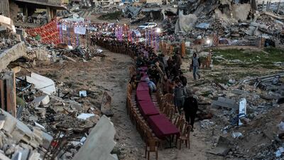 Palestinians gather amid the rubble of destroyed buildings for a communal, fast-breaking iftar meal on the second day of Ramadan in Gaza city. AFP