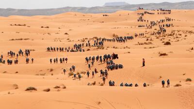 Participants cross the dunes of Merzouga on the final stage of the 28th Marathon des Sables two years ago. The final leg of the race is a charity stage to raise funds for Unicef. Pierre Verdy / AFP