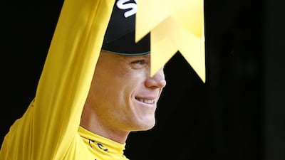 Team Sky rider Chris Froome of Great Britain celebrates on the podium retaining the overall leader's yellow jersey following the 18th stage of the Tour de France on Thursday. Yoan Valat / EPA